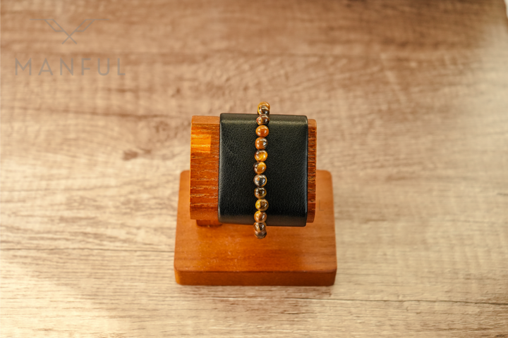 Tigers Eye Bead Bracelet, displayed on a black leather wrist stand with wood base