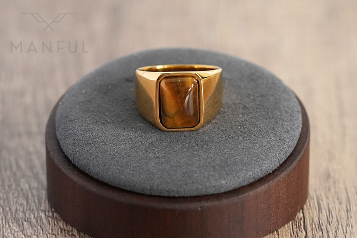 Tigers Eye Signet Ring Gold, displayed upright on a ring display cone