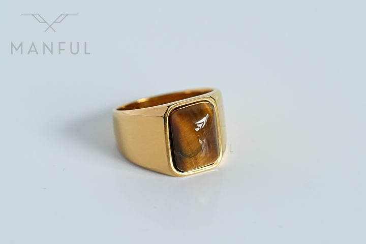 Tigers Eye Signet Ring Gold, resting in an open wooden ring box lined with grey velvet