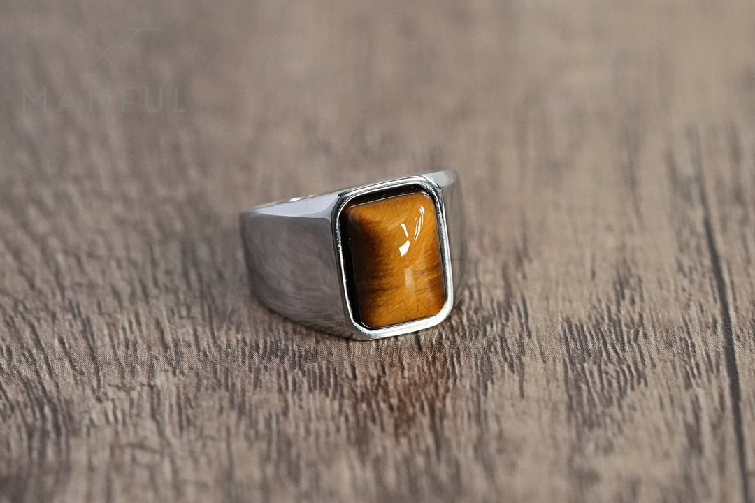 Tigers Eye Signet Ring Silver, standing upright on a wood surface, angled profile view
