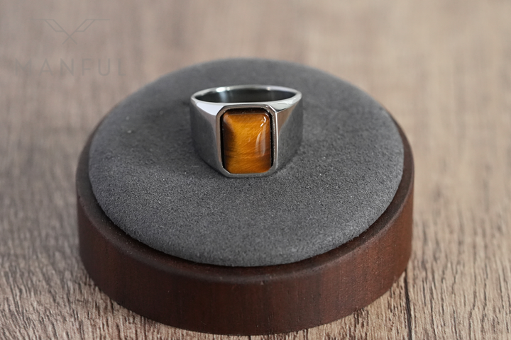 Tigers Eye Signet Ring Silver, displayed on a round wood and grey suede ring stand