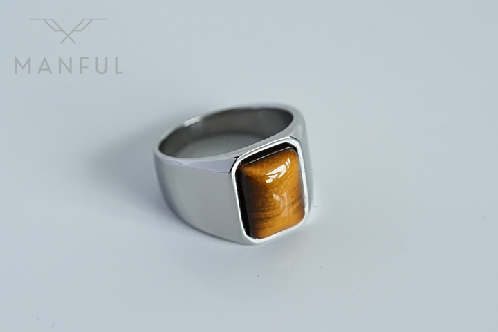Tigers Eye Signet Ring Silver, angled close-up on a plain light grey surface