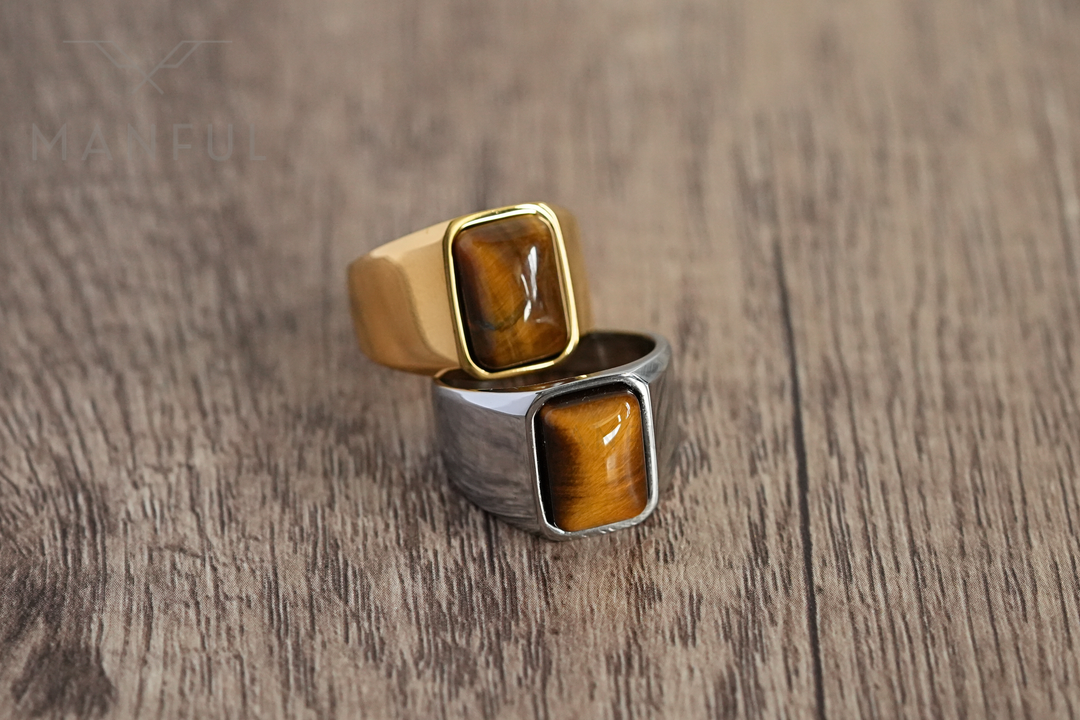 Tigers Eye Signet Ring Silver, paired beside its gold version on a wood surface