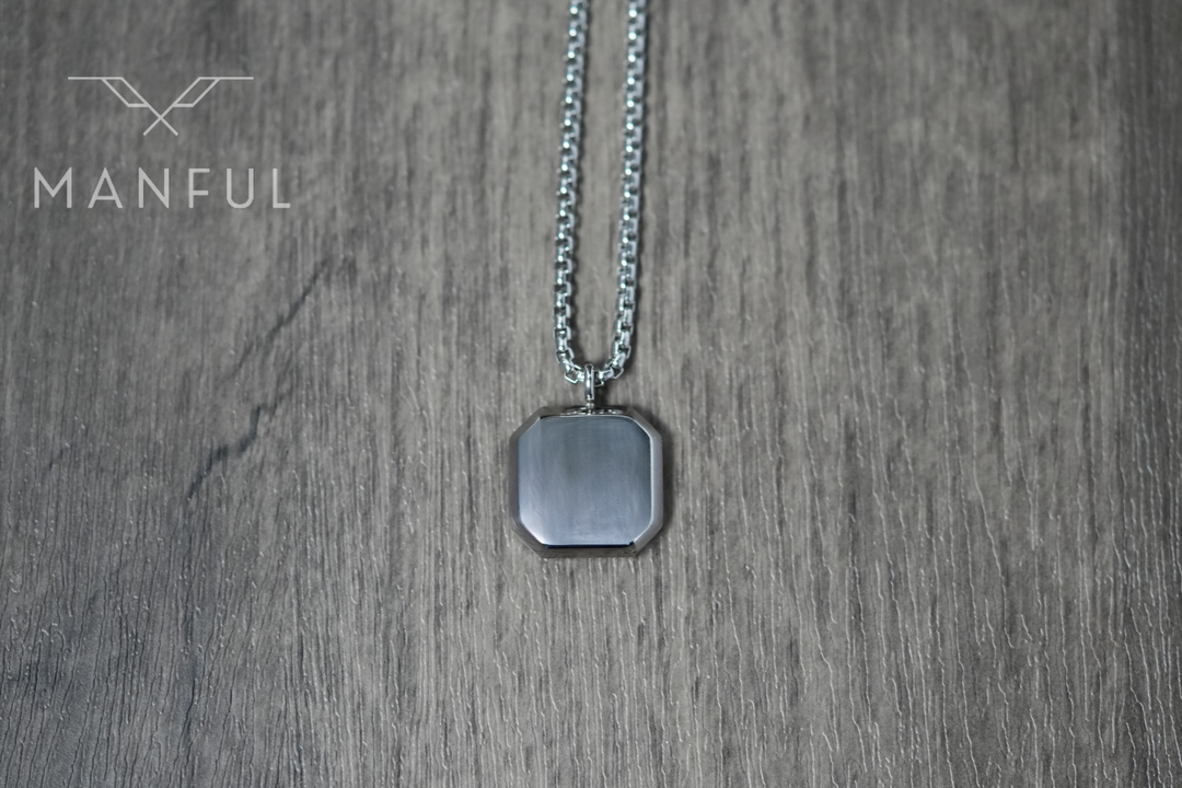 Tigers Eye Square Necklace Silver, laid on wood showing the plain reverse of the pendant