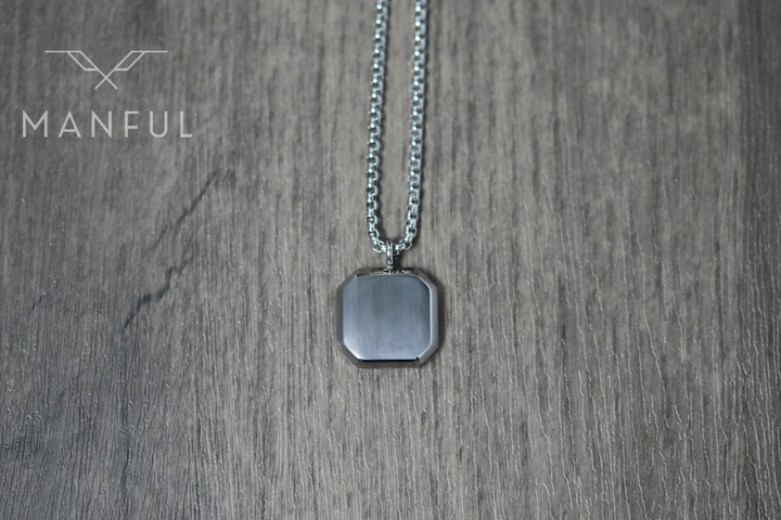 Tigers Eye Square Necklace Silver, laid on wood showing the plain reverse of the pendant