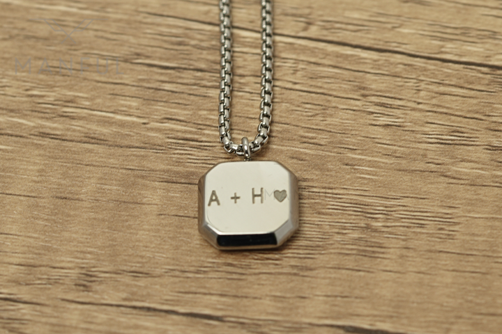 Tigers Eye Square Necklace Silver, laid on wood showing the back engraved A + H with a heart