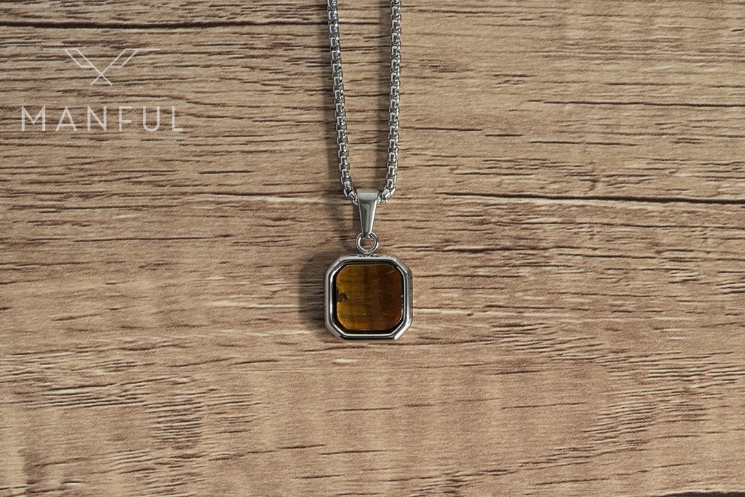 Tigers Eye Square Necklace Silver, laid flat on a wooden surface