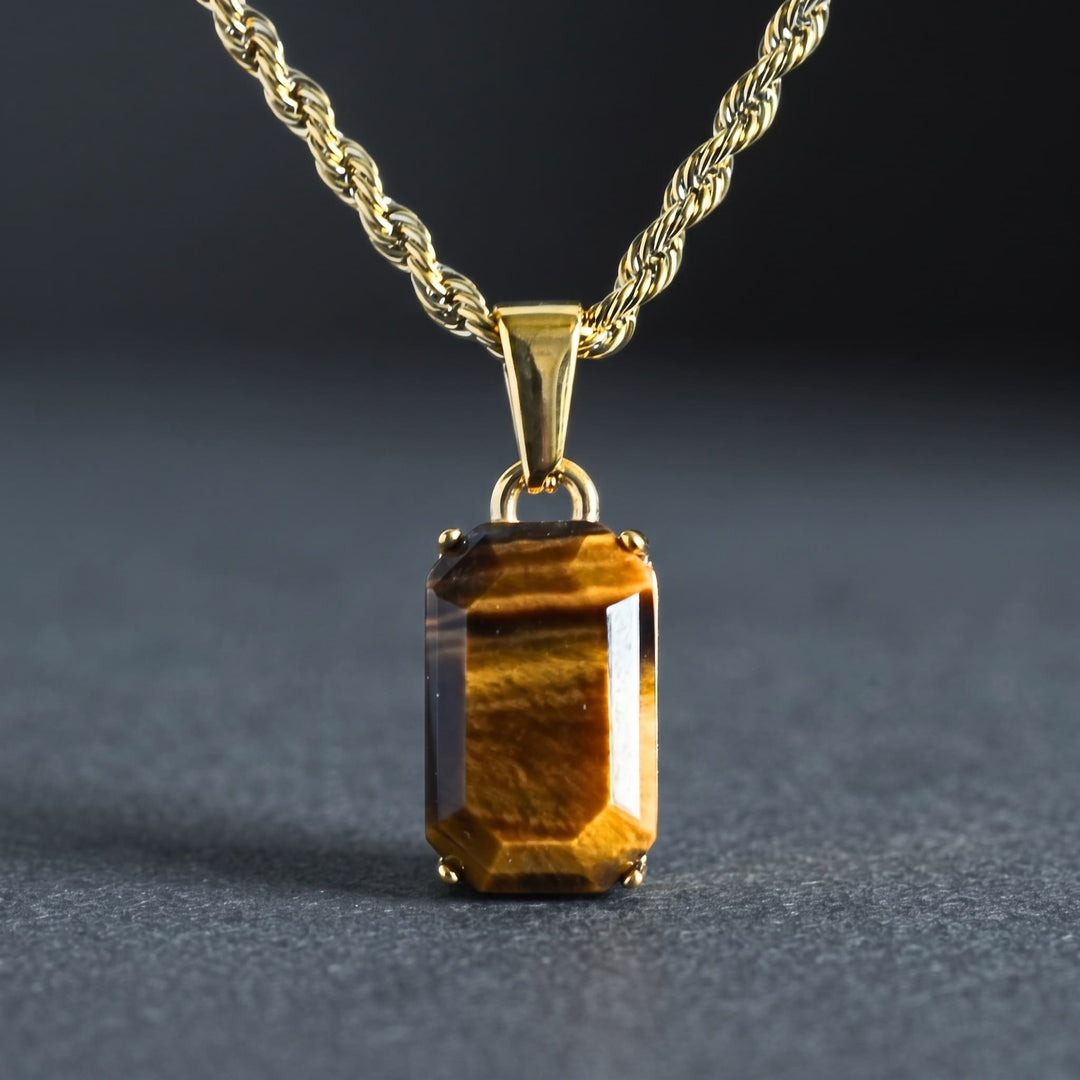 Tigers Eye Stone Pendant (Gold) on its gold rope chain against a dark charcoal backdrop