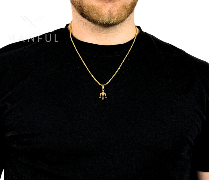 Trident Pendant Necklace Gold, worn on a man's neck over a black t-shirt