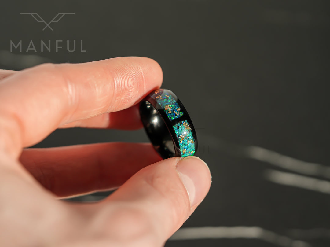 Trinity Opal Ring, held pinched between thumb and finger in close-up