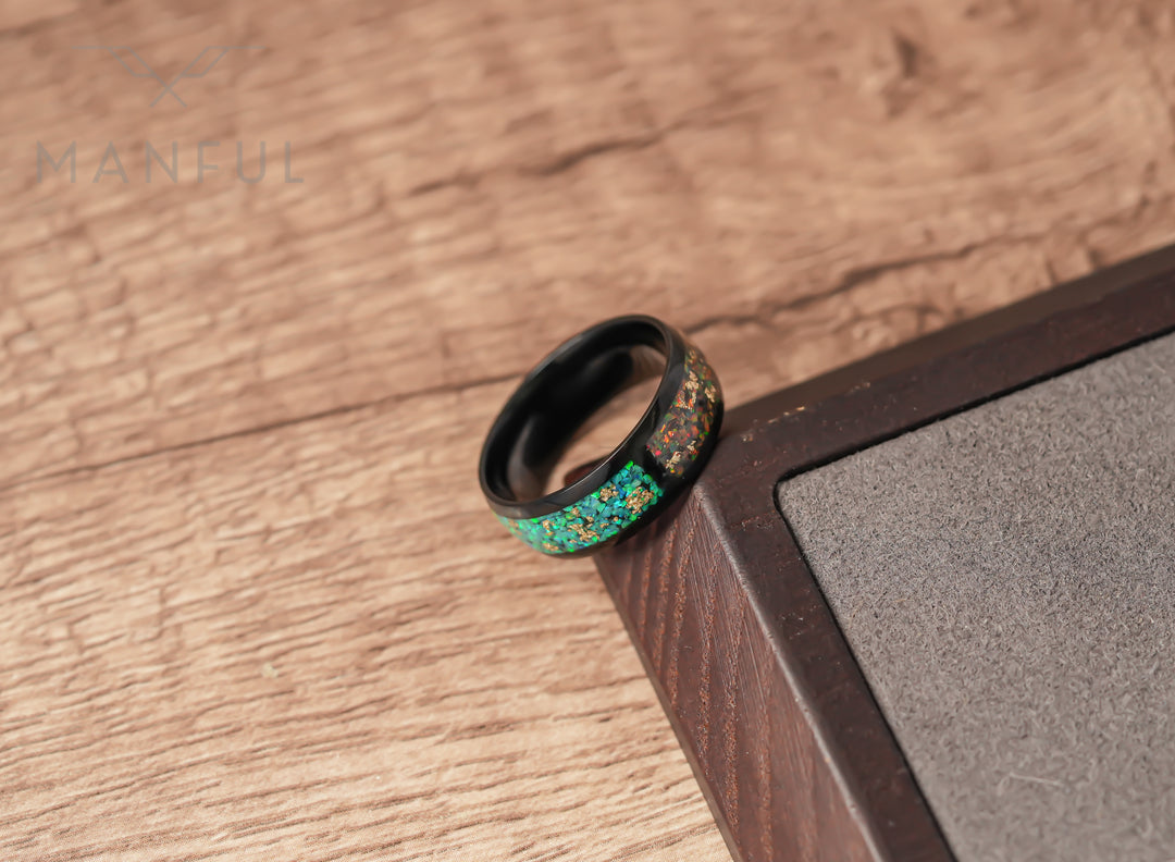 Trinity Opal Ring, leaning against a dark wood block corner on lighter wood