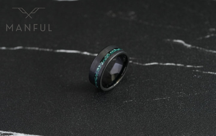Tungsten Aquamarine Inlay Band Black, resting on dark marble at a slight angle showing the teal inlay