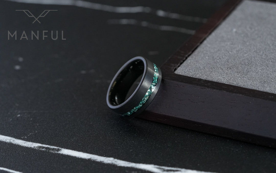 Tungsten Aquamarine Inlay Band Black, leaning against a wooden block corner on dark slate