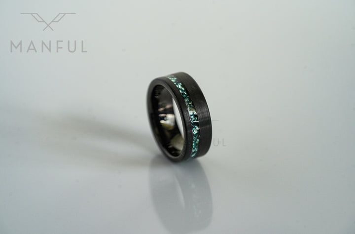 Tungsten Aquamarine Inlay Band Black, standing upright on grey with its reflection below