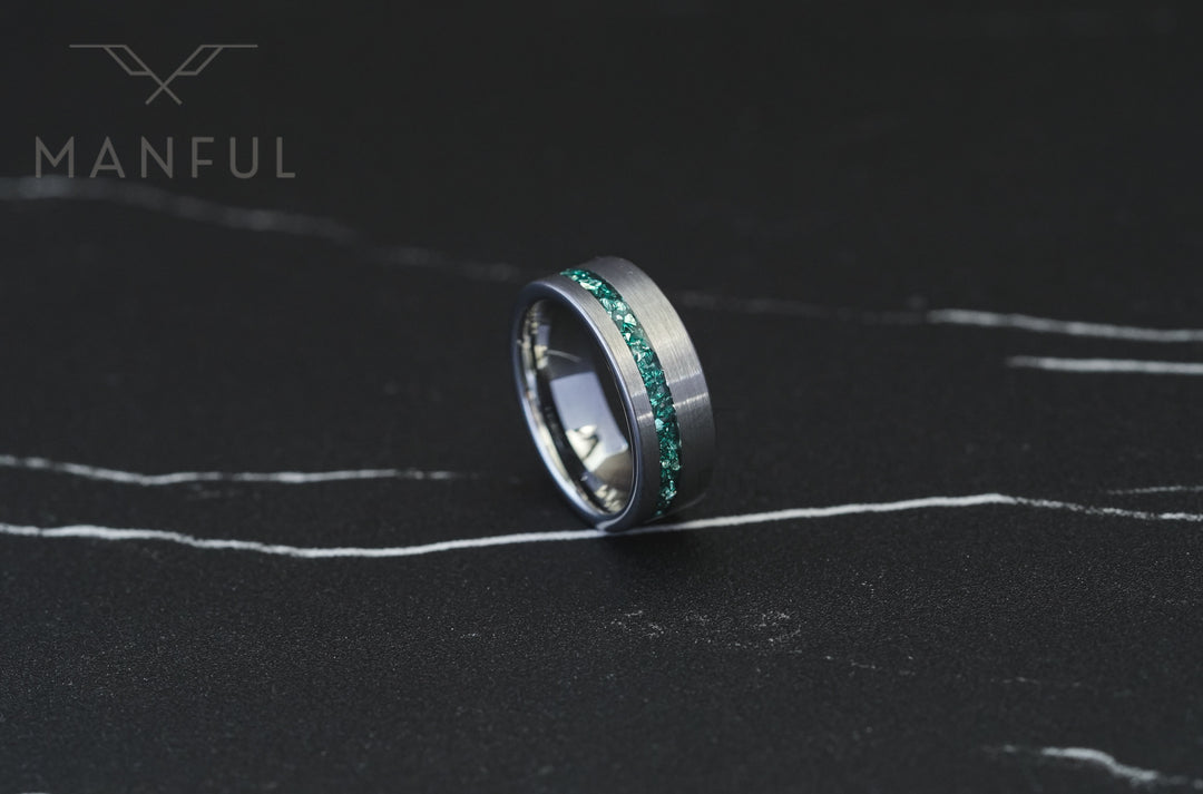 Tungsten Aquamarine Inlay Band Silver, standing on a dark marble surface with the inlay facing forward