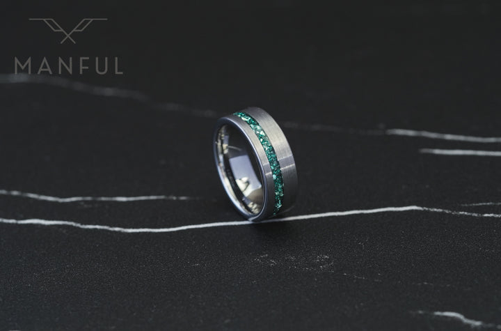 Tungsten Aquamarine Inlay Band Silver, standing on a dark marble surface with the inlay facing forward