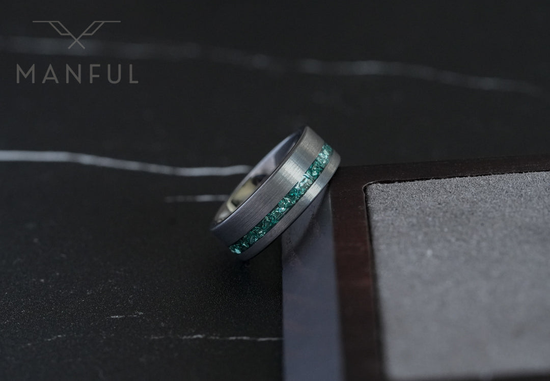 Tungsten Aquamarine Inlay Band Silver, wedged into a wooden block corner with the bore facing camera
