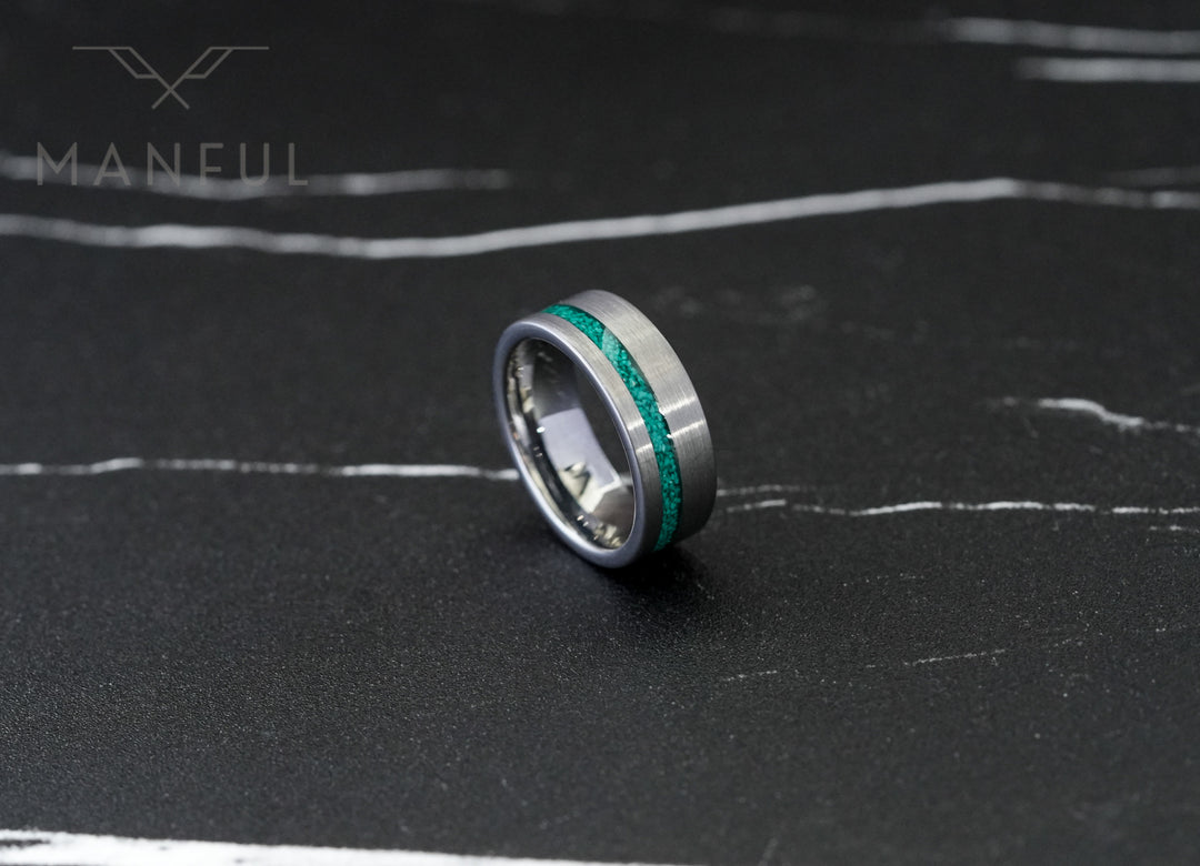 Tungsten Malachite Inlay Band Silver, standing upright on a dark marble surface with white veining