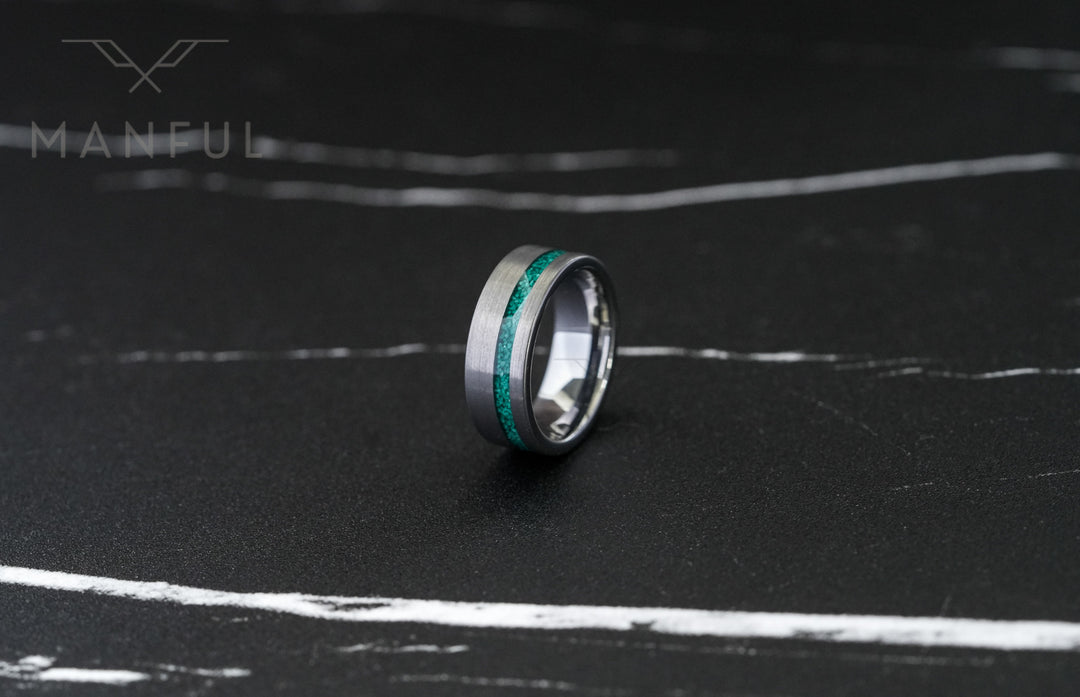 Tungsten Malachite Inlay Band Silver, lying on a dark marble surface, close-up of the inlay stripe