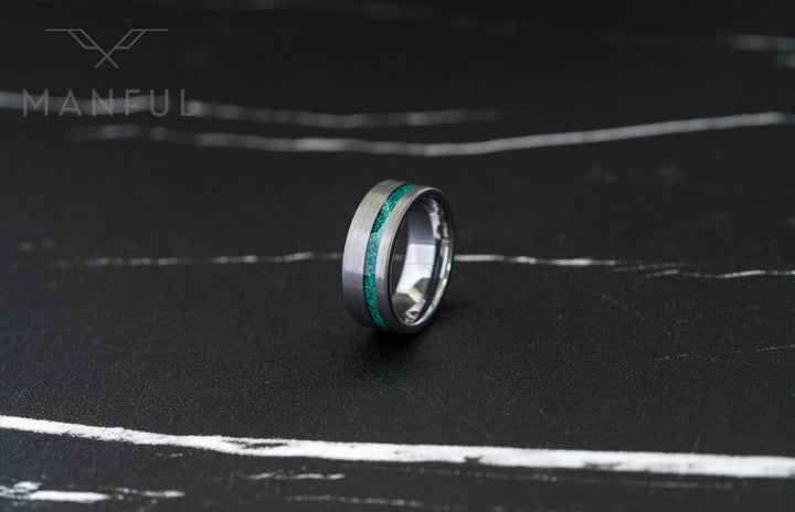 Tungsten Malachite Inlay Band Silver, lying on a dark marble surface, close-up of the inlay stripe