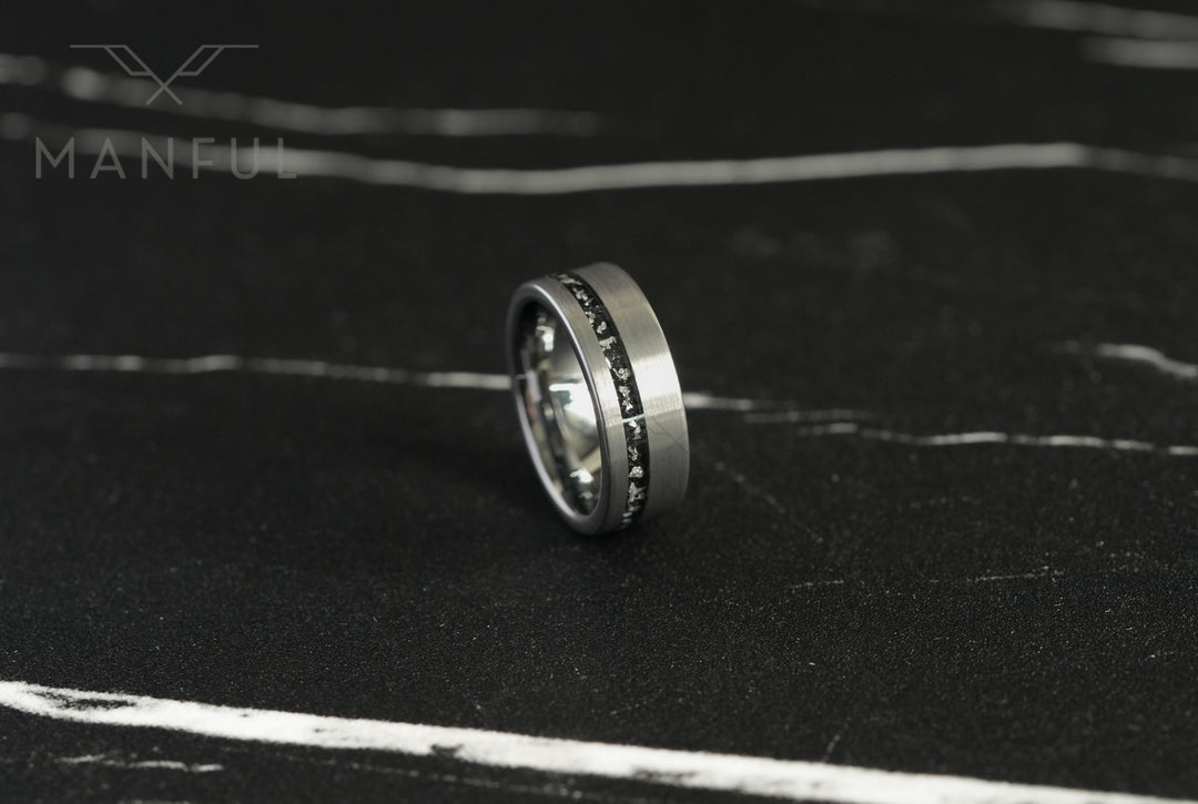 Tungsten Meteorite Inlay Band Silver, standing on a dark marble surface at an angle