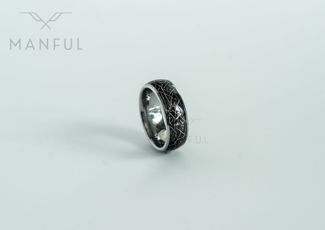 Meteorite Fragment Ring, standing at an angle on a plain grey background with its reflection below