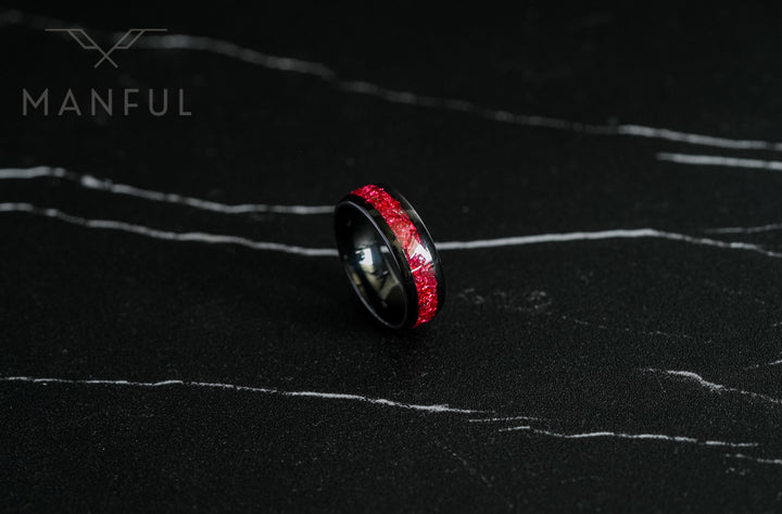 Tungsten Red Opal Black Band, resting upright on a dark marble surface showing the front face and inlay