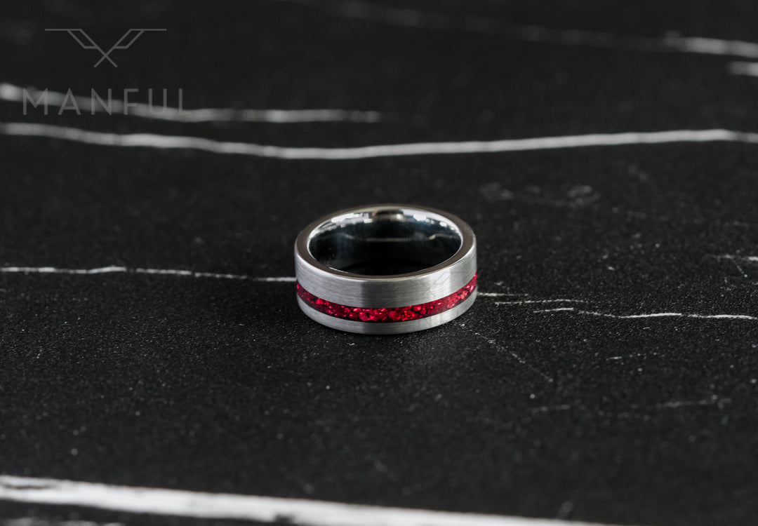 Tungsten Red Opal Inlay Band Silver, lying flat on dark marble showing the full band and dark interior