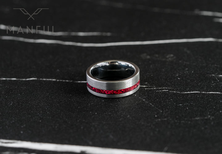 Tungsten Red Opal Inlay Band Silver, lying flat on dark marble showing the full band and dark interior