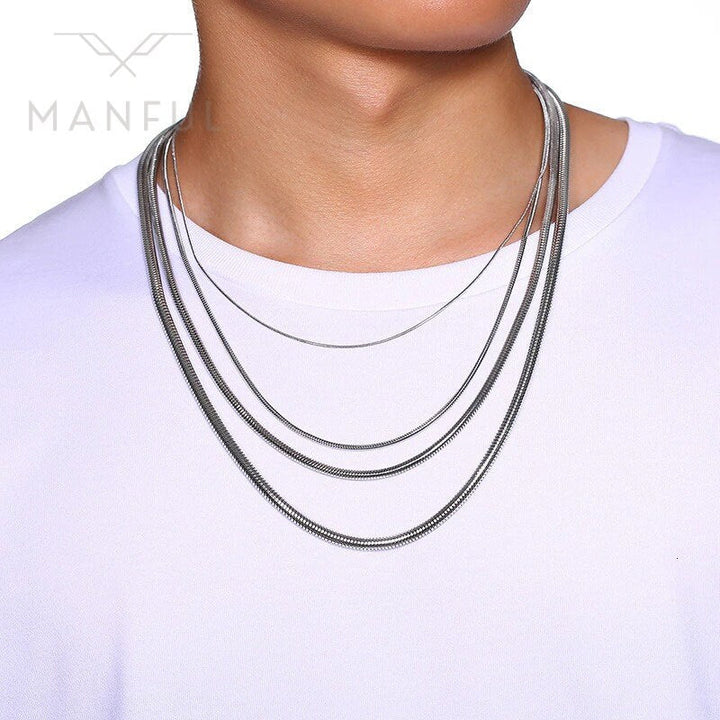 Snake Chain 2mm Silver, worn layered on a man's neck over a white t-shirt