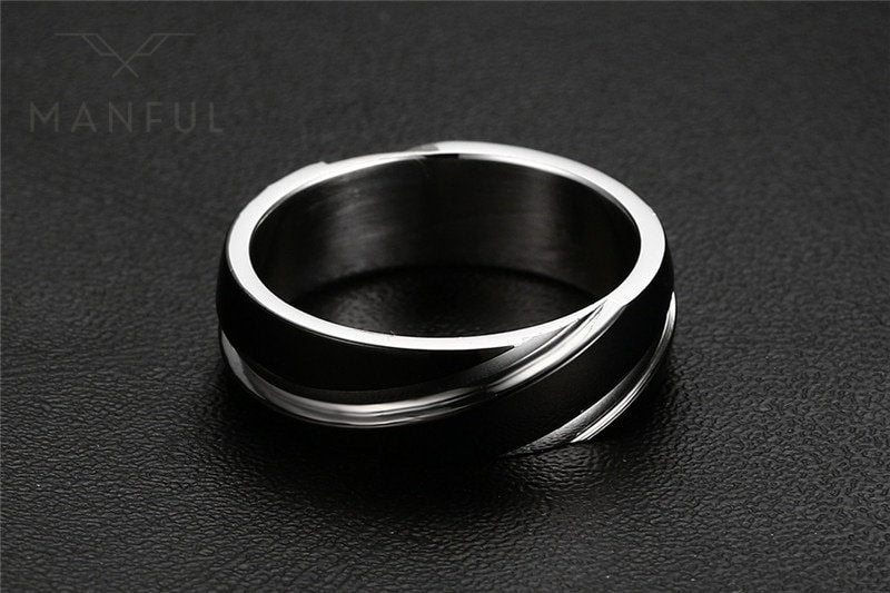 Silver Whirlwind Ring, angled on a black textured surface, leaning left