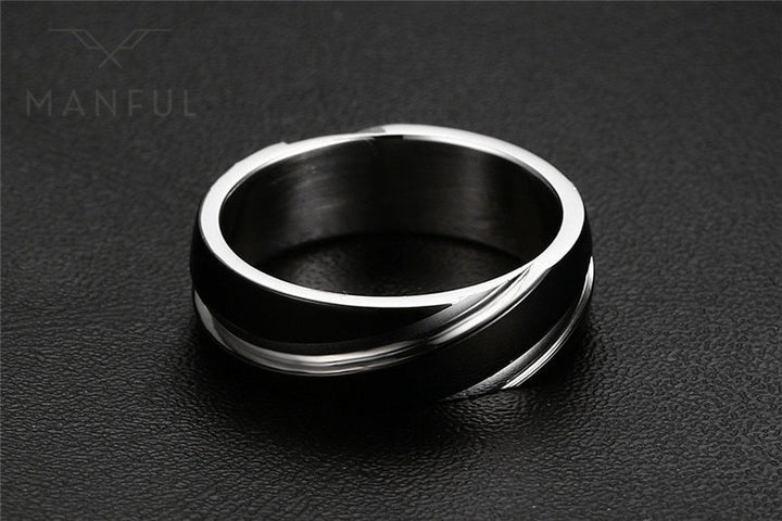 Silver Whirlwind Ring, angled on a black textured surface, leaning left