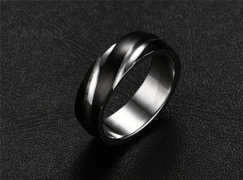 Silver Whirlwind Ring, angled on a black textured surface, tilted to show the inner band