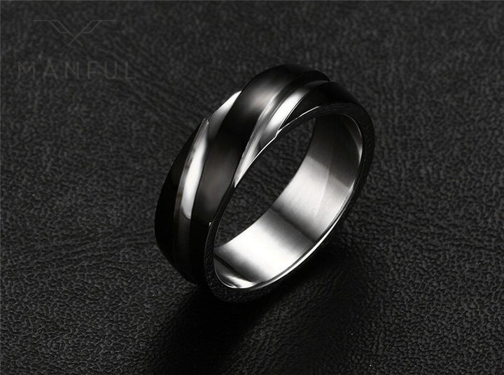 Silver Whirlwind Ring, angled on a black textured surface, tilted to show the inner band
